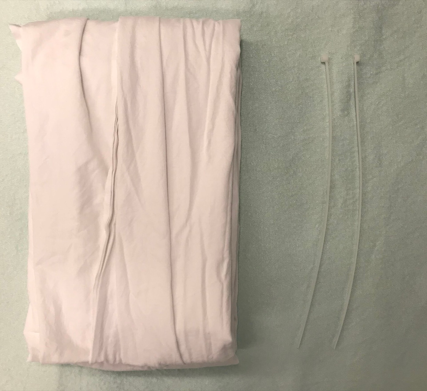 Figure 12. Equipment for an improvised pelvic binder (a folded sheet). James Heilman, MD, CC BY-SA 4.0, via Wikimedia Commons.